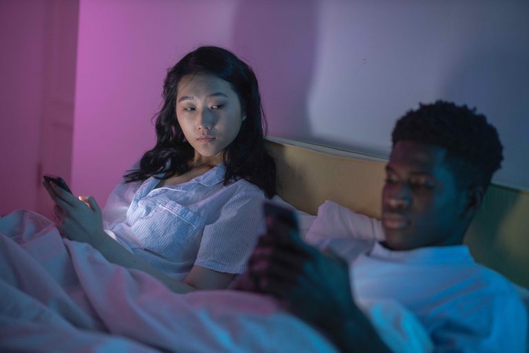 woman looking to man's phone