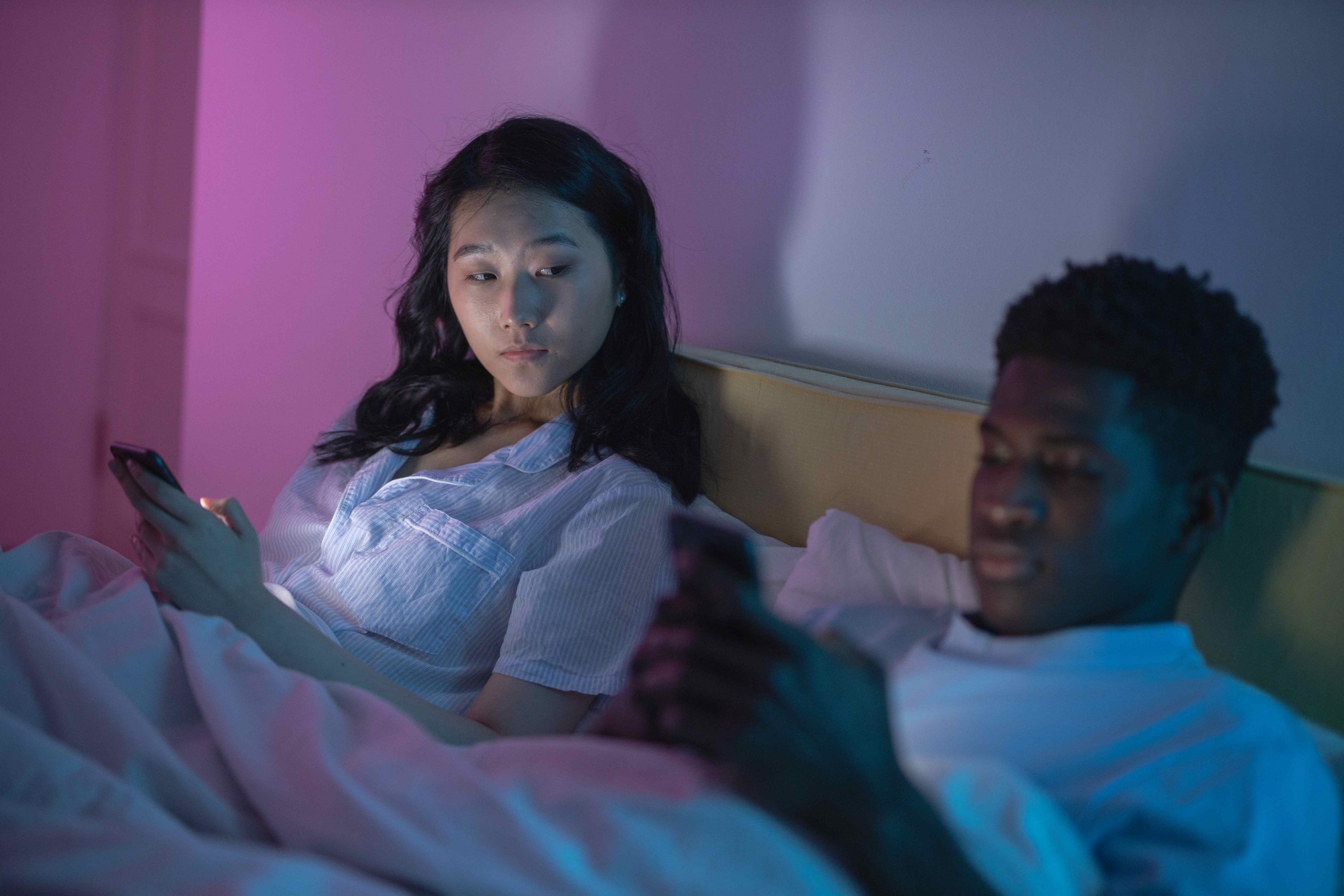 woman looking to man's phone
